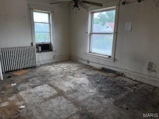 570 Washington Pl E, St Louis, IL 62205 - empty room featuring radiator heating unit, ceiling fan, and cooling unit