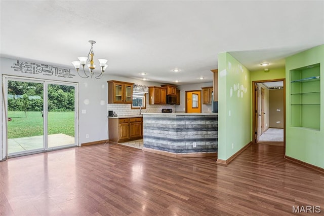 1518 Old Ripley Rd, Sorento, IL 62086 - kitchen featuring brown cabinetry, black microwave, a chandelier, wood finished floors, and light countertops