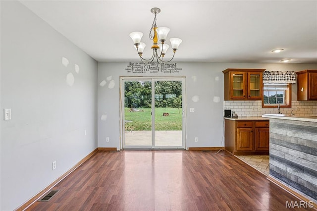 1518 Old Ripley Rd, Sorento, IL 62086 - kitchen featuring brown cabinets, a chandelier, tasteful backsplash, and light wood-style floors