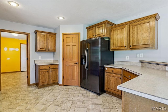 1518 Old Ripley Rd, Sorento, IL 62086 - kitchen featuring black refrigerator with ice dispenser, brown cabinets, light countertops, light stone finish flooring, and recessed lighting