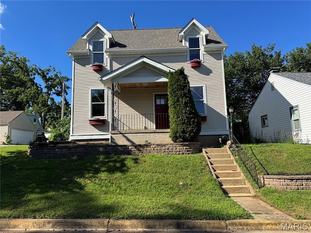 714 Decatur St, Saint Charles, MO 63301 - view of front of house featuring a front yard, a shingled roof, and covered porch