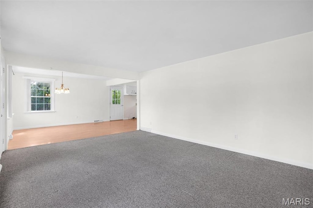 114 Macarthur St, New Haven, MO 63068 - spare room featuring carpet flooring, a chandelier, and healthy amount of natural light