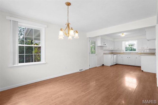 114 Macarthur St, New Haven, MO 63068 - kitchen with a chandelier, dishwasher, light countertops, white cabinets, and light wood-type flooring