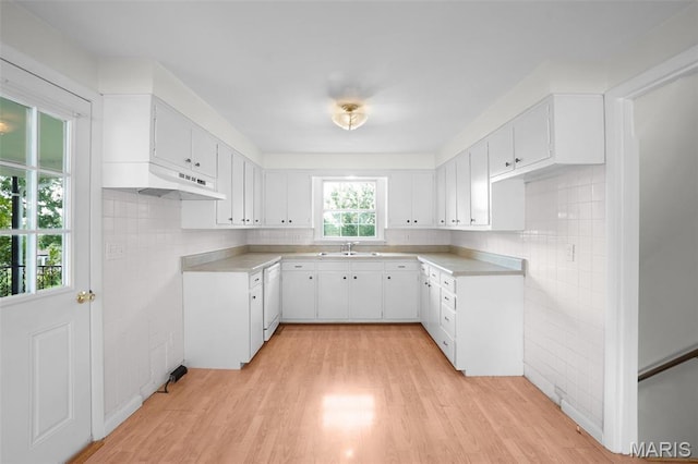 114 Macarthur St, New Haven, MO 63068 - kitchen featuring under cabinet range hood, dishwasher, light wood-type flooring, white cabinetry, and light countertops