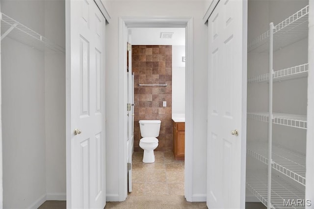 32 Brushy Brook Ct, Ofallon, MO 63366 - bathroom featuring tile walls, tile patterned floors, vanity, and a closet