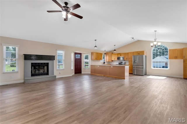 2601 Brookfield Ct, Columbia, IL 62236 - unfurnished living room with vaulted ceiling, plenty of natural light, a fireplace with raised hearth, ceiling fan, and a chandelier