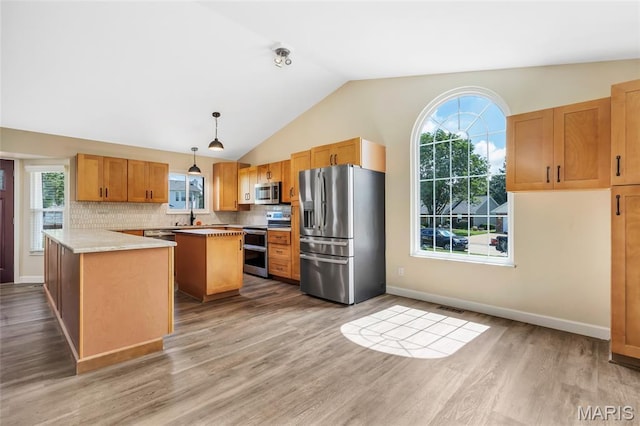 2601 Brookfield Ct, Columbia, IL 62236 - kitchen with appliances with stainless steel finishes, vaulted ceiling, light countertops, wood finished floors, and decorative backsplash