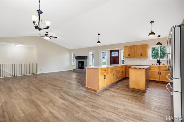 2601 Brookfield Ct, Columbia, IL 62236 - kitchen featuring freestanding refrigerator, lofted ceiling, a chandelier, open floor plan, and light countertops