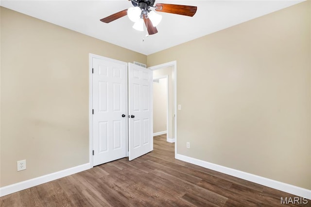 2601 Brookfield Ct, Columbia, IL 62236 - unfurnished bedroom featuring dark wood finished floors, a ceiling fan, and a closet