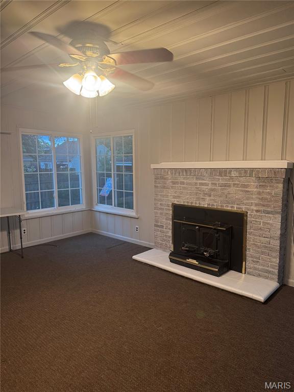2544 State St, Granite City, IL 62040 - unfurnished living room with ceiling fan, dark colored carpet, and a decorative wall