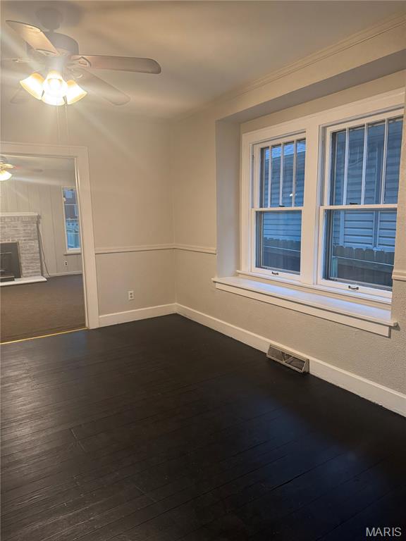 2544 State St, Granite City, IL 62040 - spare room featuring ceiling fan and dark wood-style flooring