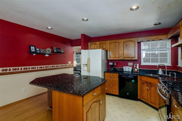 2364 Marine Rd, Highland, IL 62249 - kitchen featuring dishwasher, white fridge with ice dispenser, gas stove, brown cabinets, and a textured ceiling