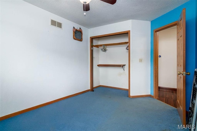 2364 Marine Rd, Highland, IL 62249 - unfurnished bedroom featuring a closet, a textured ceiling, carpet, and ceiling fan