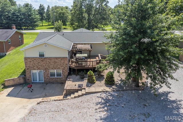 2364 Marine Rd, Highland, IL 62249 - rear view of house with a patio, a deck, brick siding, and a lawn