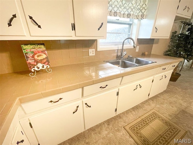 304 W Oak St, Dexter, MO 63841 - kitchen with tasteful backsplash, white cabinets, and tile counters