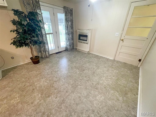 304 W Oak St, Dexter, MO 63841 - unfurnished living room with heating unit and baseboards