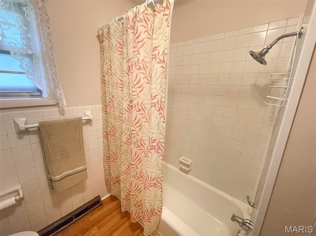 304 W Oak St, Dexter, MO 63841 - full bathroom featuring tile walls, shower / bathtub combination with curtain, wood finished floors, and wainscoting