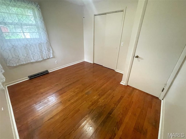 304 W Oak St, Dexter, MO 63841 - unfurnished bedroom featuring wood finished floors and a closet