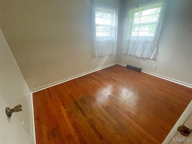 304 W Oak St, Dexter, MO 63841 - empty room with dark wood-type flooring and baseboards