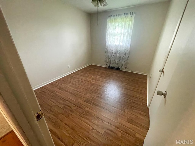 304 W Oak St, Dexter, MO 63841 - spare room featuring wood finished floors and baseboards