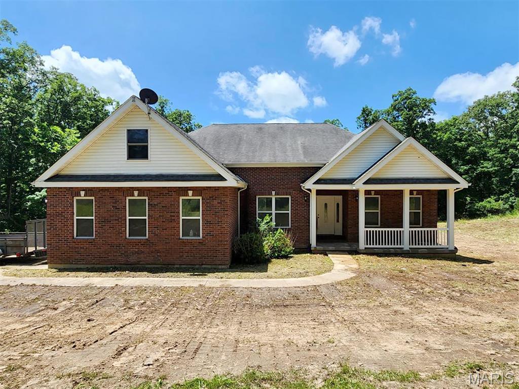 24479 Schuetzenground Rd, Warrenton, MO 63383 - view of front facade featuring covered porch and brick siding