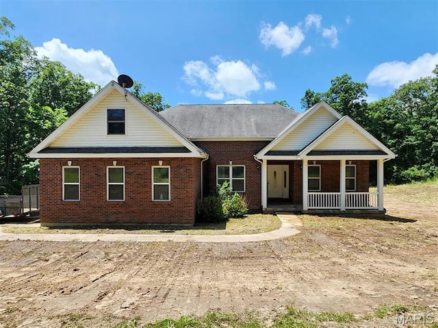 24479 Schuetzenground Rd, Warrenton, MO 63383 - view of front facade featuring covered porch and brick siding