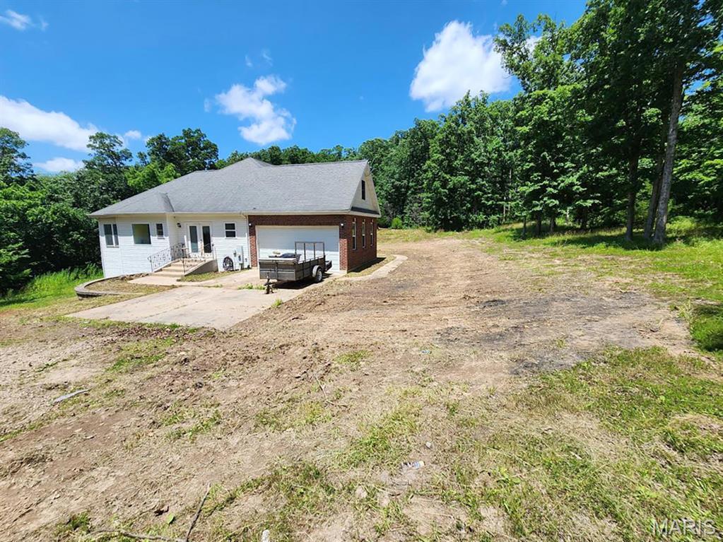 24479 Schuetzenground Rd, Warrenton, MO 63383 - view of front of house featuring driveway and an attached garage