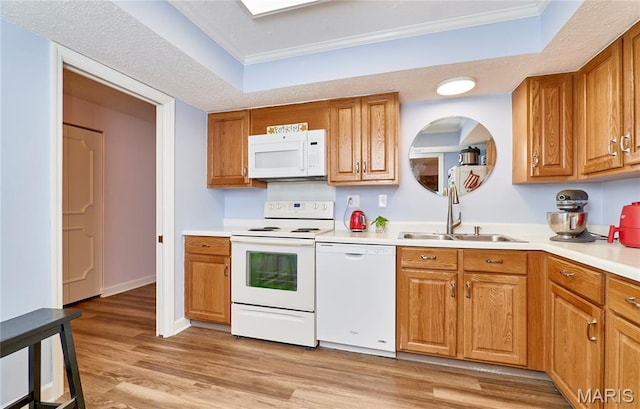 922 Claytonbrook Dr Unit 2, Ballwin, MO 63011 - kitchen featuring white appliances, a raised ceiling, light wood-style flooring, crown molding, and light countertops