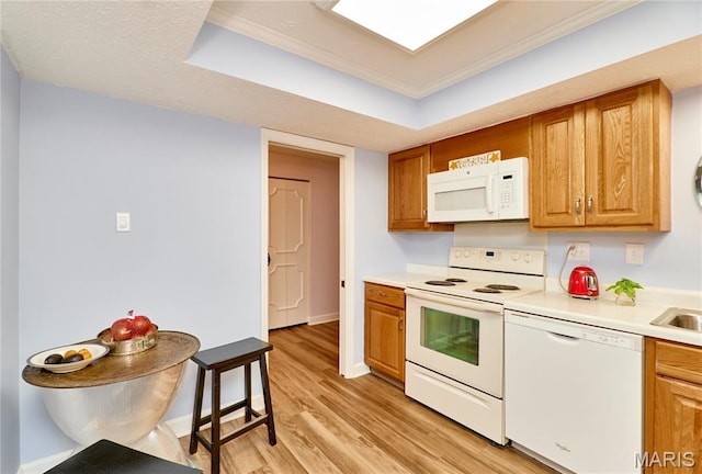 922 Claytonbrook Dr Unit 2, Ballwin, MO 63011 - kitchen featuring white appliances, light wood-type flooring, crown molding, light countertops, and brown cabinets