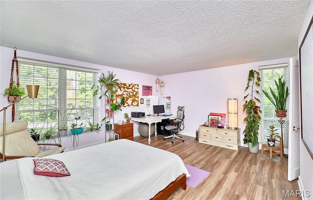 922 Claytonbrook Dr Unit 2, Ballwin, MO 63011 - bedroom with wood finished floors, a textured ceiling, and an office area
