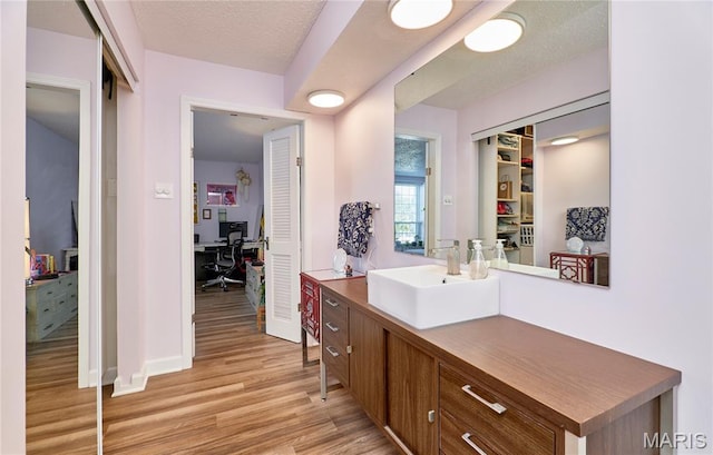 922 Claytonbrook Dr Unit 2, Ballwin, MO 63011 - bathroom featuring wood finished floors and vanity