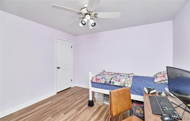 922 Claytonbrook Dr Unit 2, Ballwin, MO 63011 - bedroom with wood finished floors, a ceiling fan, and a textured ceiling