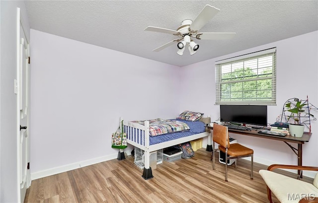 922 Claytonbrook Dr Unit 2, Ballwin, MO 63011 - bedroom featuring wood finished floors, a textured ceiling, and a ceiling fan