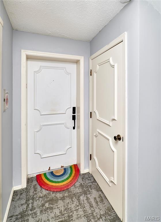 922 Claytonbrook Dr Unit 2, Ballwin, MO 63011 - doorway to outside with carpet flooring and a textured ceiling