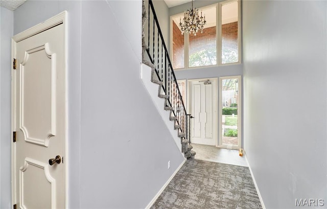 922 Claytonbrook Dr Unit 2, Ballwin, MO 63011 - carpeted entrance foyer with stairway, a chandelier, and a towering ceiling