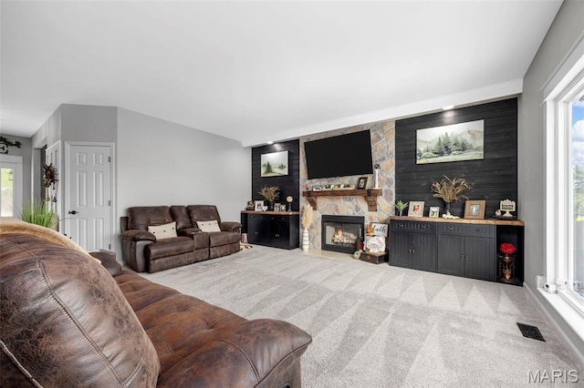 7742 Ardmore Dr, Ofallon, MO 63368 - carpeted living room with plenty of natural light, a fireplace, and lofted ceiling