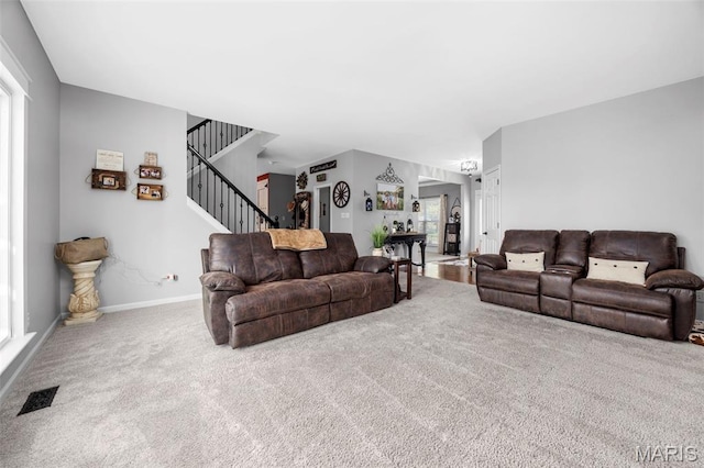 7742 Ardmore Dr, Ofallon, MO 63368 - carpeted living area with healthy amount of natural light and stairs