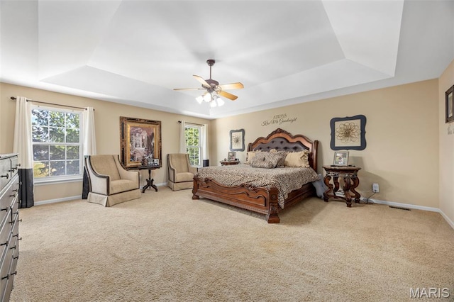 7742 Ardmore Dr, Ofallon, MO 63368 - carpeted bedroom featuring a tray ceiling and ceiling fan