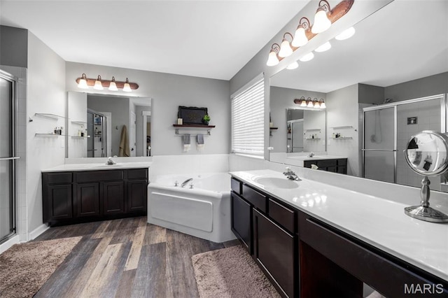 7742 Ardmore Dr, Ofallon, MO 63368 - full bath featuring wood finished floors, a shower stall, two vanities, and a garden tub