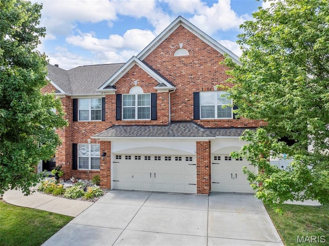 7742 Ardmore Dr, Ofallon, MO 63368 - traditional home featuring driveway, an attached garage, brick siding, and a shingled roof