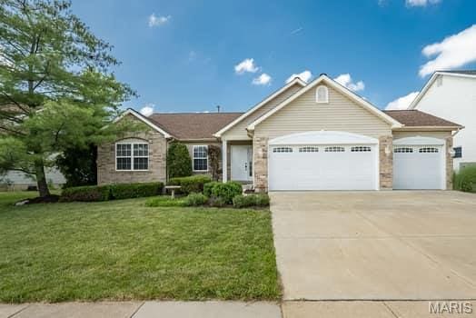 1405 Sunburst Dr, O'Fallon, MO 63366 - ranch-style home with an attached garage, concrete driveway, a front lawn, and stone siding