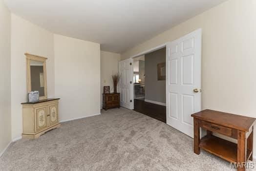 1405 Sunburst Dr, O'Fallon, MO 63366 - unfurnished bedroom featuring carpet flooring