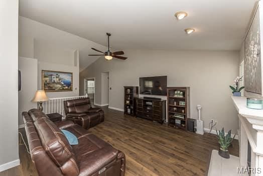 1405 Sunburst Dr, O'Fallon, MO 63366 - living area with wood finished floors, a ceiling fan, and lofted ceiling