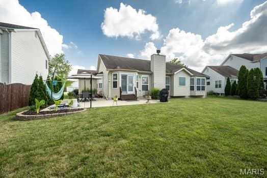 1405 Sunburst Dr, O'Fallon, MO 63366 - rear view of property featuring a patio, a chimney, and entry steps