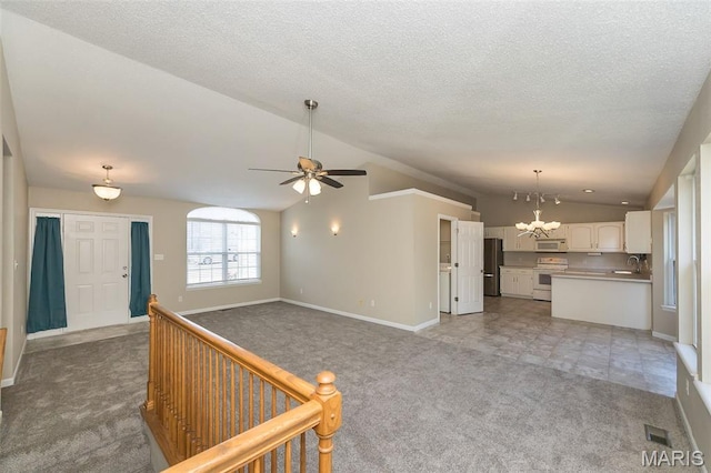 563 Great Plains Dr, House Springs, MO 63051 - unfurnished living room featuring lofted ceiling, light carpet, a chandelier, ceiling fan, and a textured ceiling