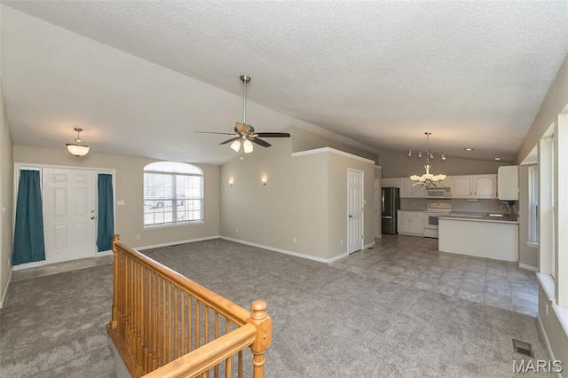 563 Great Plains Dr, House Springs, MO 63051 - unfurnished living room with lofted ceiling, light carpet, a chandelier, a ceiling fan, and a textured ceiling