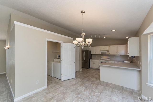 563 Great Plains Dr, House Springs, MO 63051 - kitchen featuring white appliances, washer and clothes dryer, a chandelier, white cabinets, and light countertops