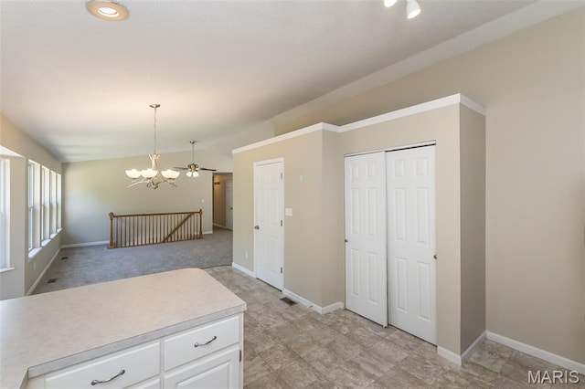 563 Great Plains Dr, House Springs, MO 63051 - kitchen with vaulted ceiling, light countertops, a chandelier, white cabinetry, and hanging light fixtures