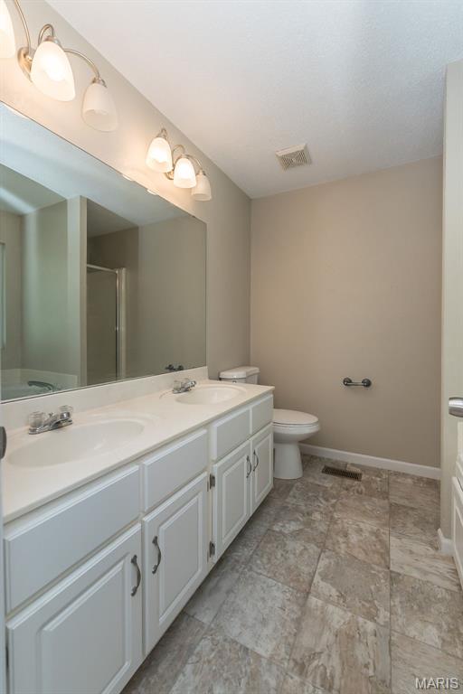 563 Great Plains Dr, House Springs, MO 63051 - full bath with double vanity and an enclosed shower