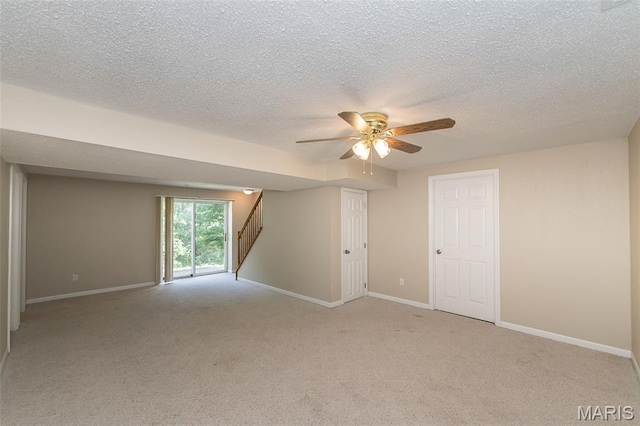 563 Great Plains Dr, House Springs, MO 63051 - spare room featuring ceiling fan, a textured ceiling, stairway, and light colored carpet